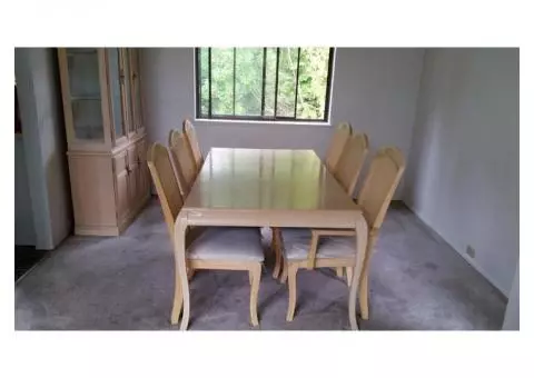 Dining room table with six chairs and matching hutch.